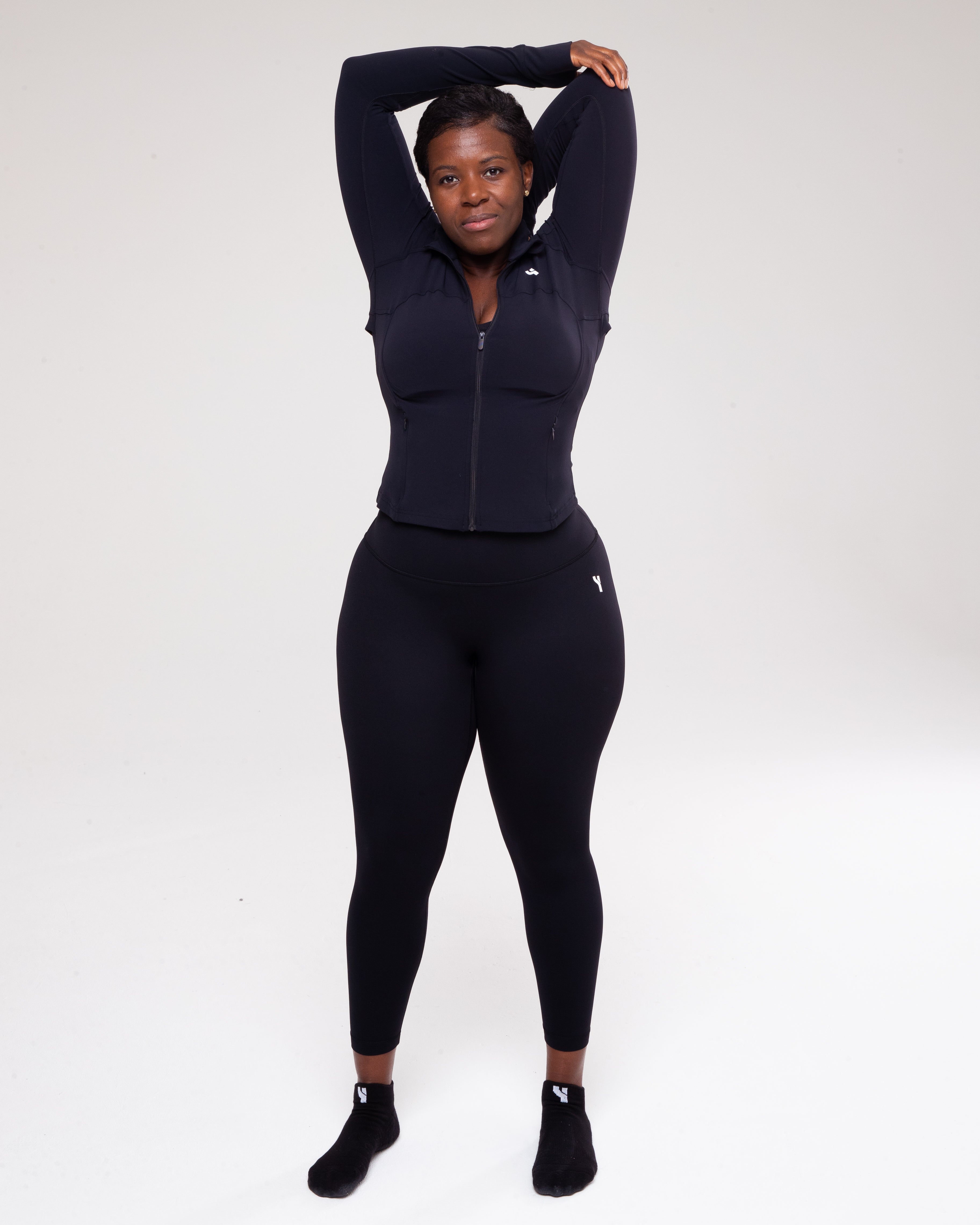 Sculpt 1/4 Zip Jacket in black full height model shot from the front active pose