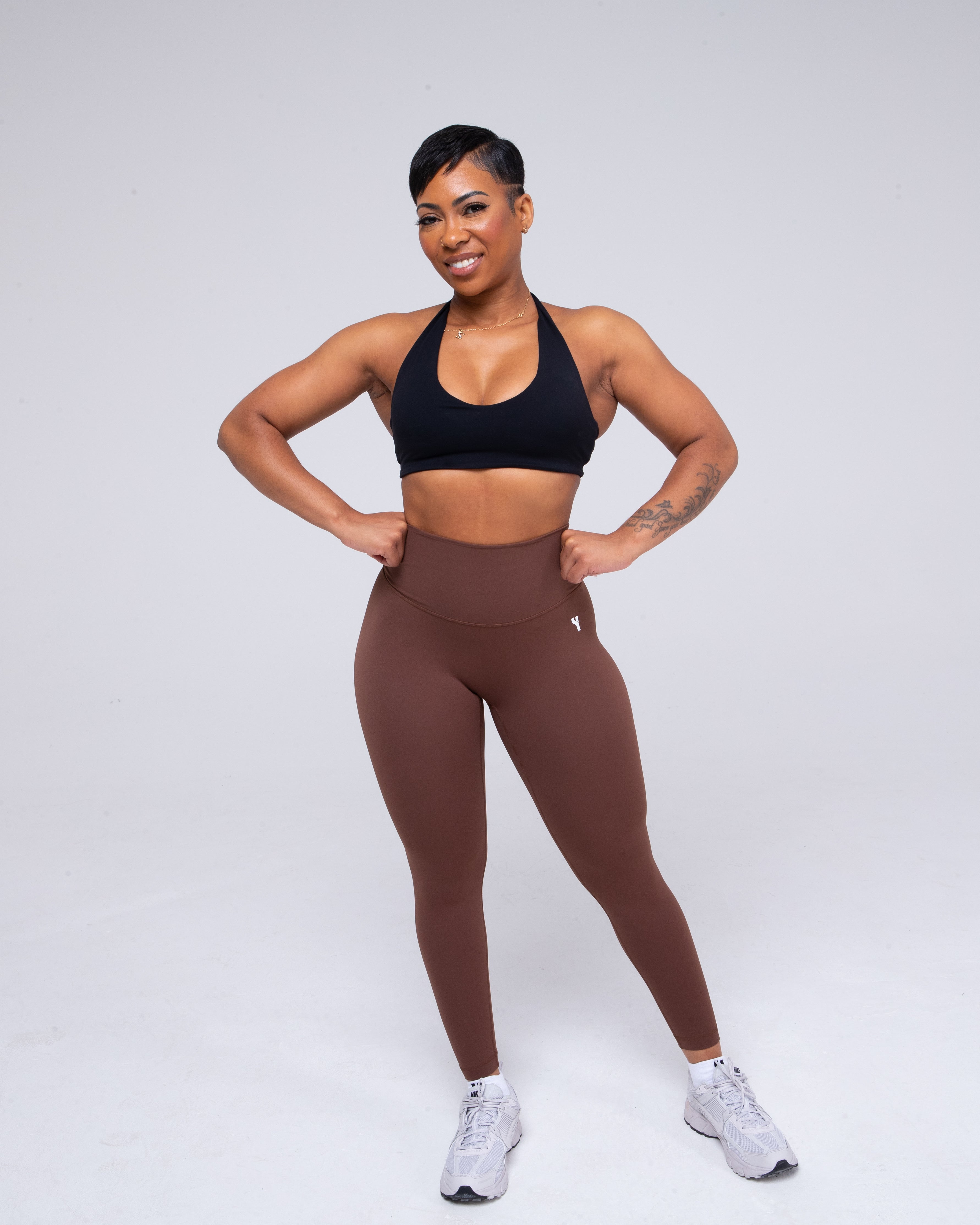 Sculpt Halterneck Sports Bra in black full height model shot from the front active pose